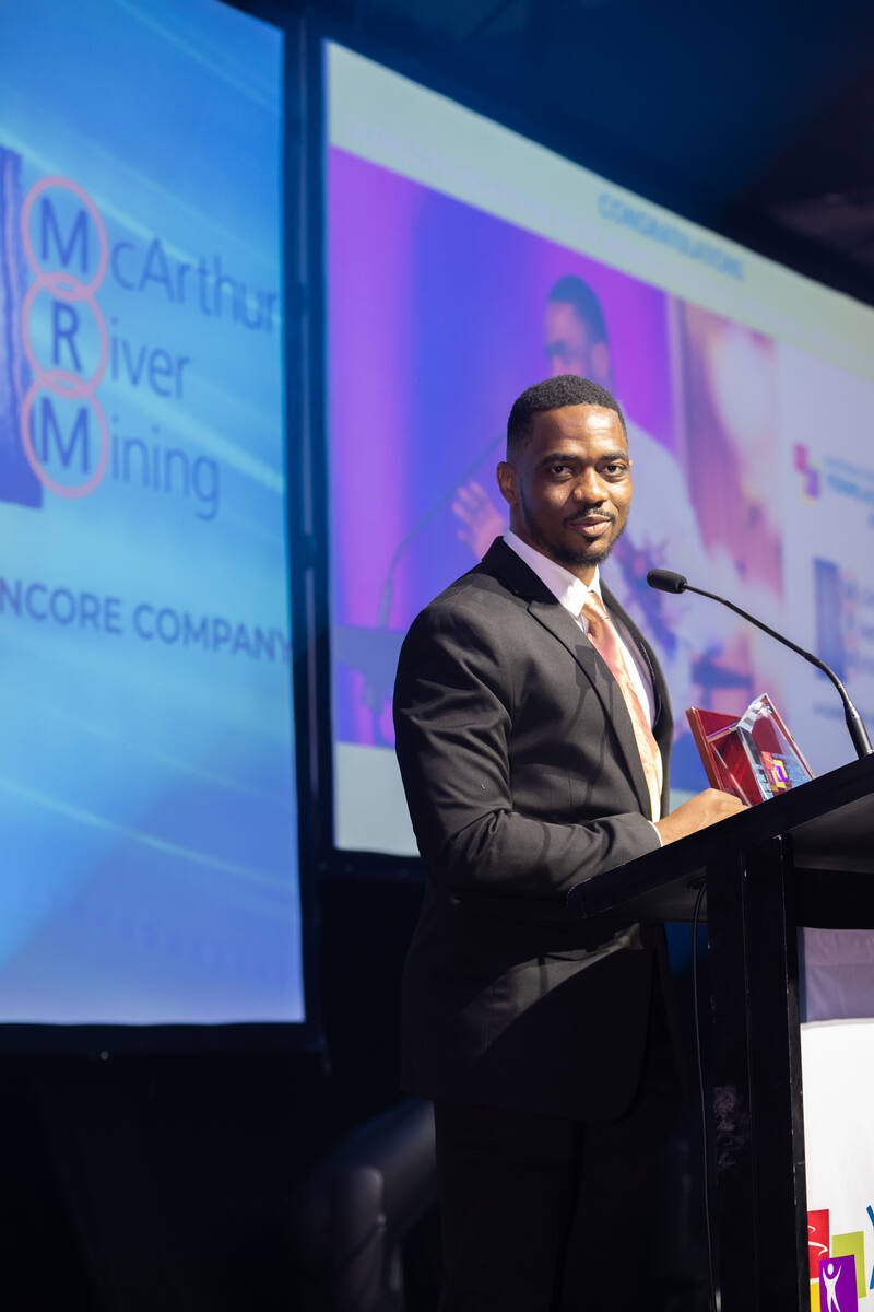 Joel Benesha speaking at an event